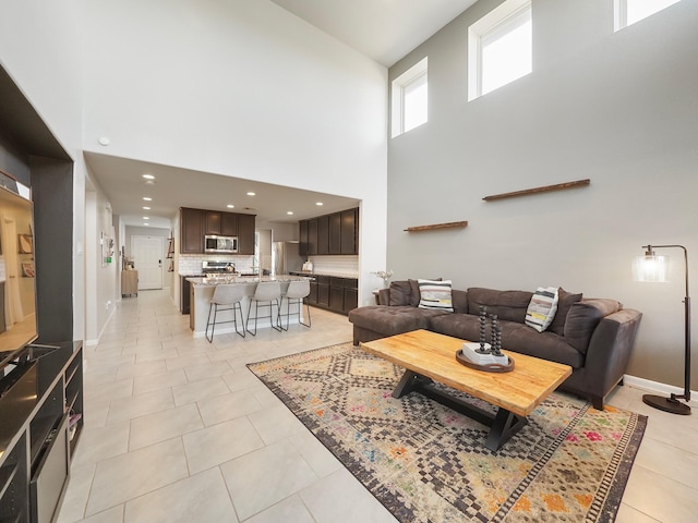 tiled living room with a high ceiling