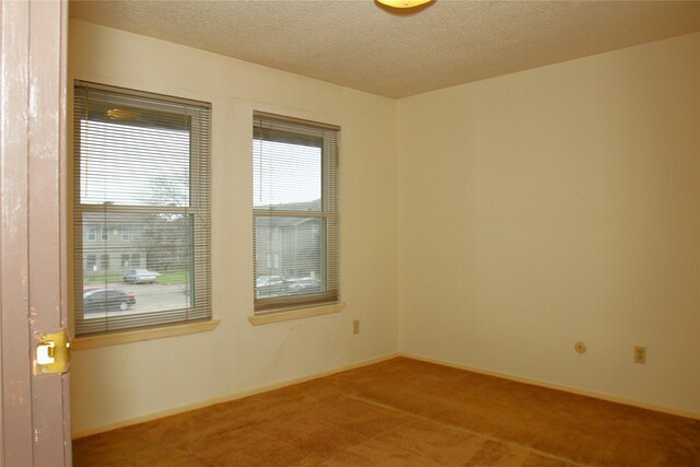 418 Garland Dr Unit 222, Lake Jackson, TX 77566 - carpeted spare room with a textured ceiling and baseboards