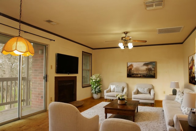 living area featuring a wealth of natural light, visible vents, and crown molding