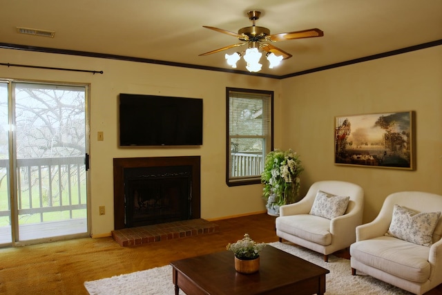 418 Garland Dr Unit 222, Lake Jackson, TX 77566 - carpeted living room featuring a ceiling fan, a brick fireplace, visible vents, and crown molding