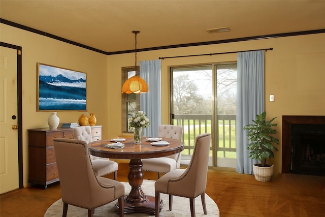 418 Garland Dr Unit 222, Lake Jackson, TX 77566 - carpeted dining space with crown molding, visible vents, and a fireplace