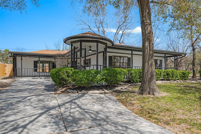 view of front of house featuring driveway and fence