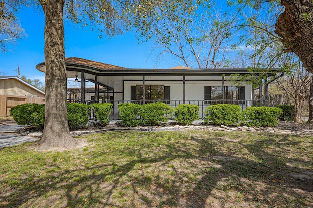 back of house with a yard, stucco siding, and fence