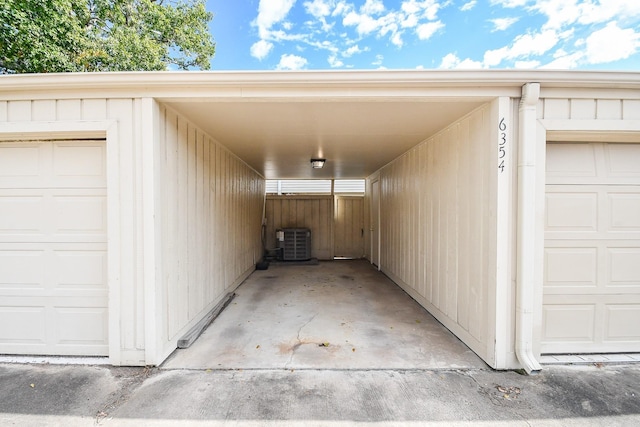 garage featuring central AC unit and a carport