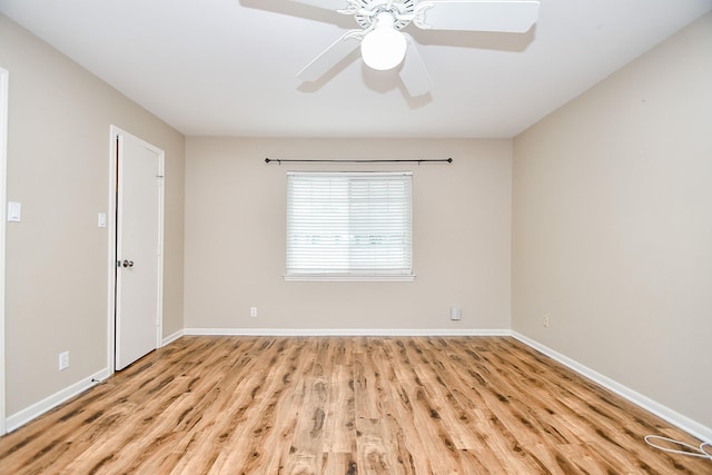 spare room featuring light hardwood / wood-style floors and ceiling fan