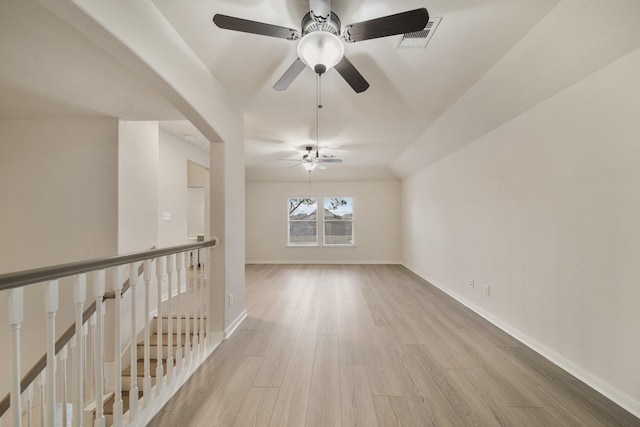 spare room featuring light wood-style floors, visible vents, and baseboards