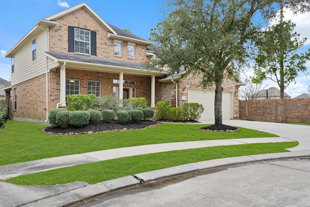 traditional home with brick siding, concrete driveway, a front yard, fence, and a garage