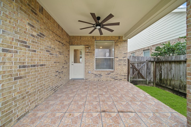 view of patio / terrace featuring ceiling fan, a gate, and fence