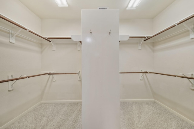 spacious closet with light carpet and visible vents