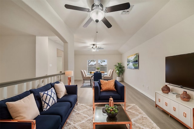 living area featuring light wood-style floors and baseboards