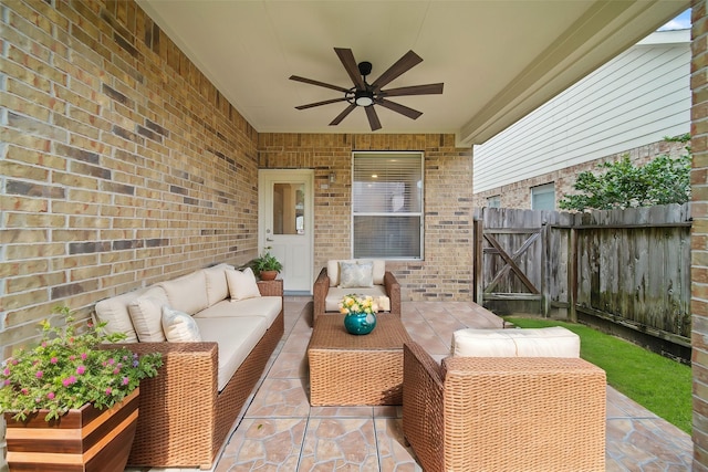 view of patio / terrace featuring an outdoor living space, fence, a ceiling fan, and a gate