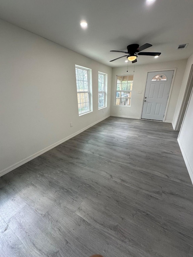 interior space with ceiling fan and dark wood-type flooring