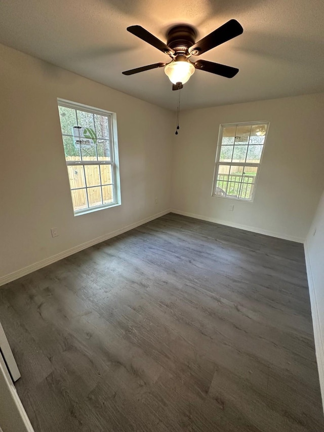 spare room with ceiling fan, dark wood-type flooring, and a textured ceiling