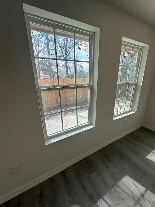 spare room featuring hardwood / wood-style flooring and plenty of natural light