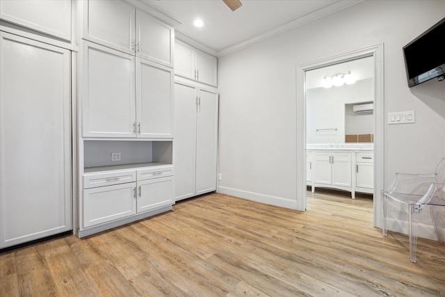 interior space with ceiling fan, light hardwood / wood-style floors, and a wall unit AC