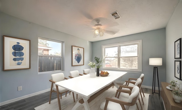 dining area featuring ceiling fan and dark wood-type flooring