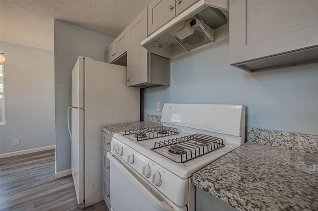 kitchen with white cabinetry, wood-type flooring, a textured ceiling, and gas range gas stove