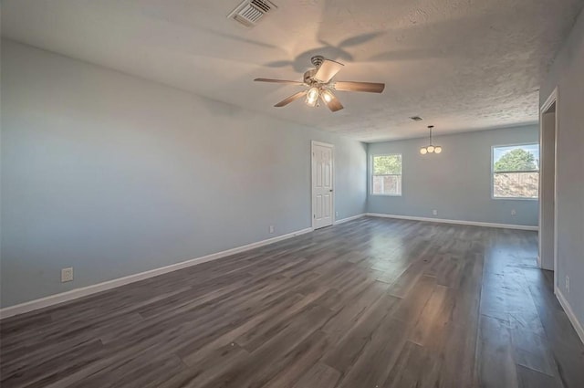 empty room featuring a textured ceiling, ceiling fan, and dark hardwood / wood-style floors