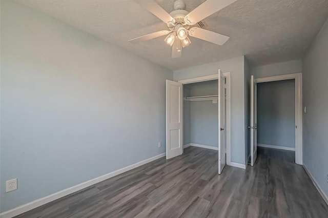 unfurnished bedroom with a textured ceiling, a closet, ceiling fan, and dark hardwood / wood-style flooring