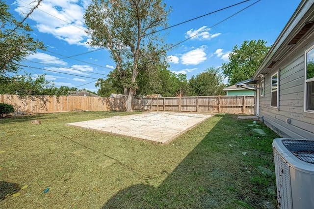 view of yard featuring cooling unit and a patio area