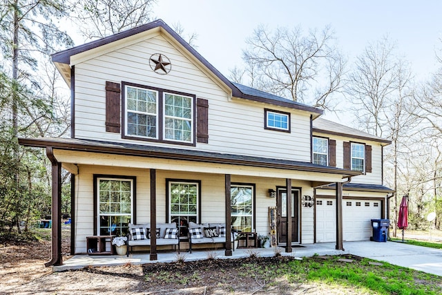 view of front of house featuring covered porch and a garage