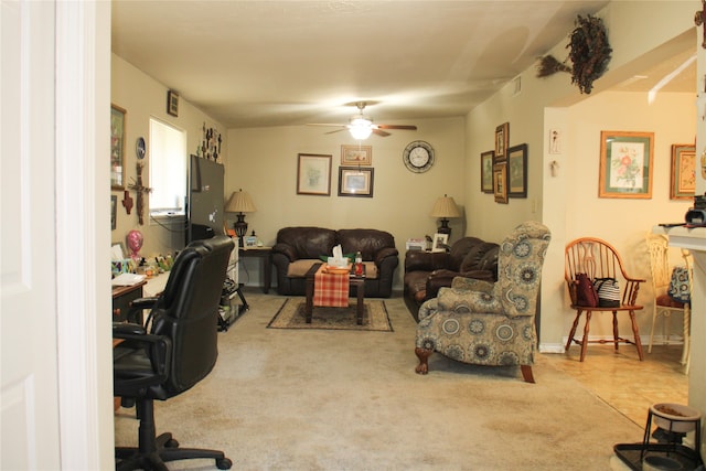 carpeted living room with ceiling fan