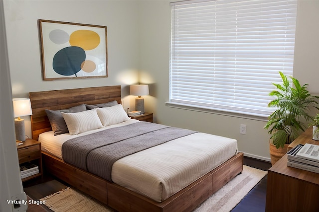 bedroom with dark wood-type flooring