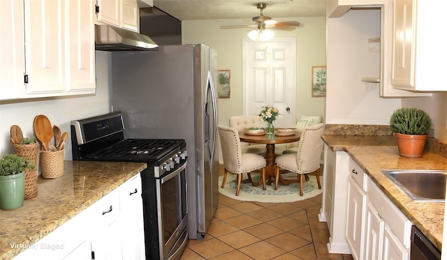 kitchen featuring white cabinetry, stainless steel gas stove, light stone counters, and light tile patterned floors