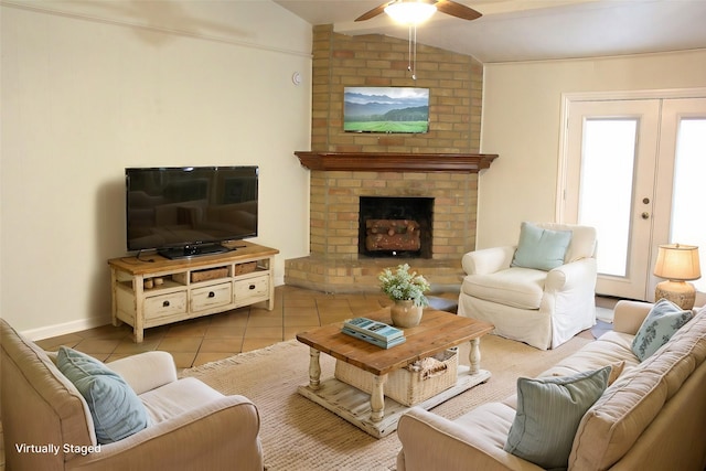 tiled living room featuring lofted ceiling, ceiling fan, french doors, and a fireplace