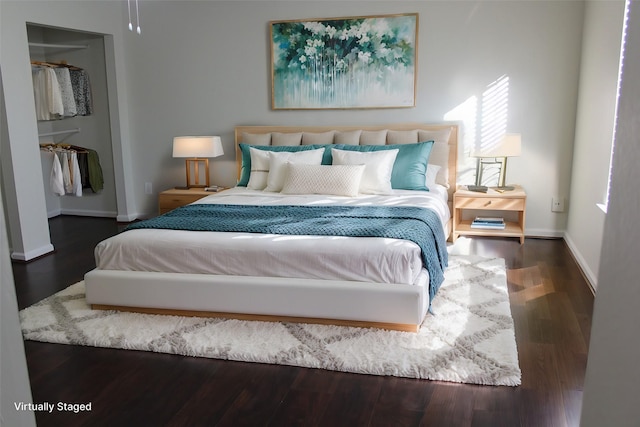 bedroom with a closet and dark hardwood / wood-style flooring