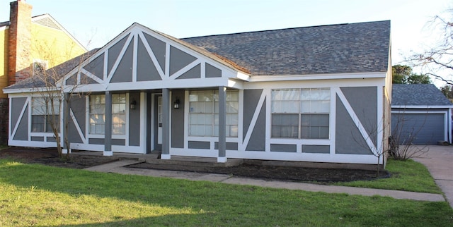 tudor-style house with a garage and a front yard