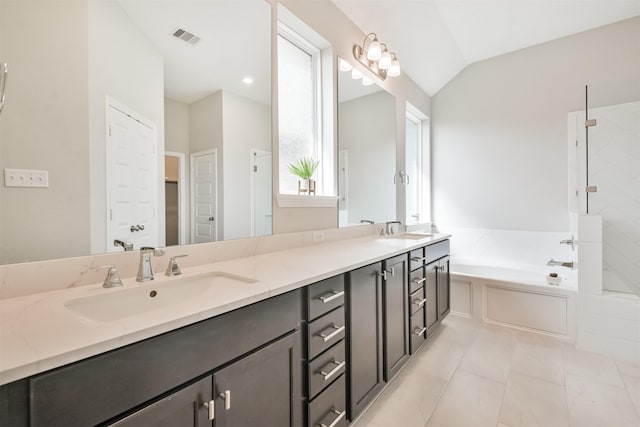 bathroom featuring tile patterned floors, separate shower and tub, vanity, and lofted ceiling