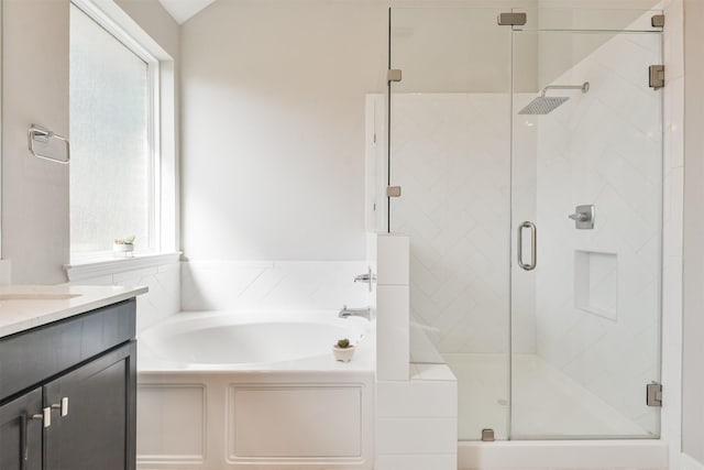 bathroom featuring vanity and independent shower and bath