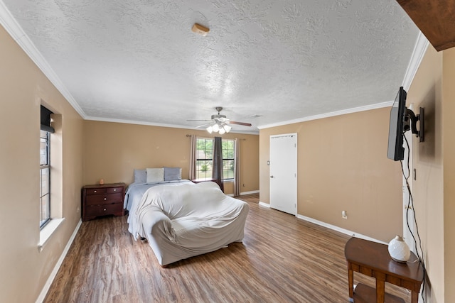 bedroom featuring hardwood / wood-style flooring, ornamental molding, a textured ceiling, and ceiling fan