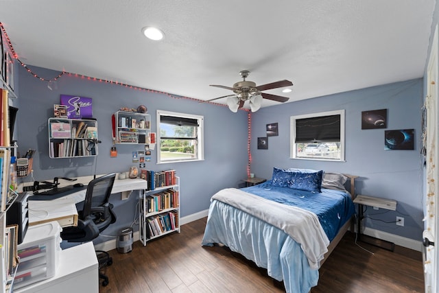 bedroom with ceiling fan and dark hardwood / wood-style floors