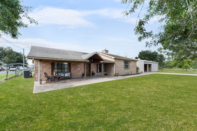 rear view of property featuring brick siding, central AC, and a yard