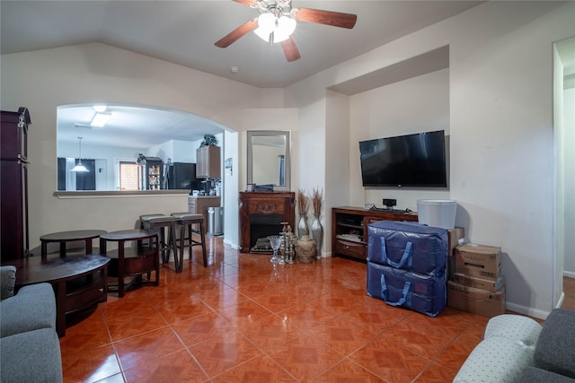 tiled living room with vaulted ceiling and ceiling fan