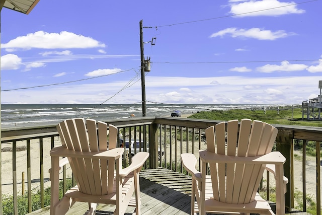 balcony featuring a water view and a view of the beach