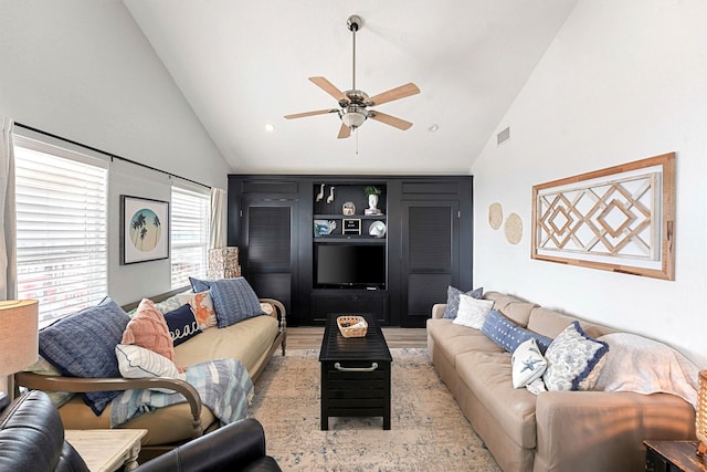 living room featuring ceiling fan, high vaulted ceiling, and light hardwood / wood-style flooring