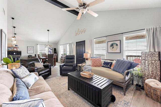 living room featuring light hardwood / wood-style floors, high vaulted ceiling, and ceiling fan