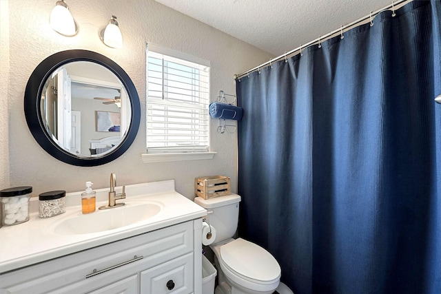 bathroom featuring a textured ceiling, vanity, and toilet