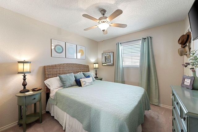 carpeted bedroom featuring ceiling fan and a textured ceiling