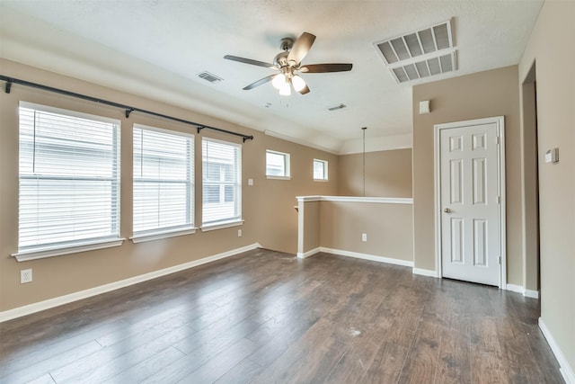 unfurnished room with ceiling fan and dark wood-type flooring