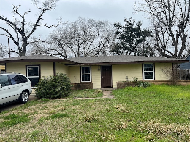 view of front of property with a front lawn and brick siding