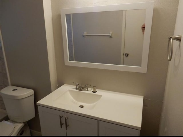 half bath with vanity and toilet