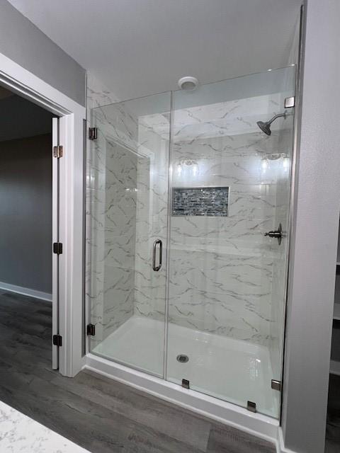 bathroom featuring an enclosed shower and hardwood / wood-style floors