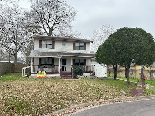 view of front of house with covered porch and a front lawn