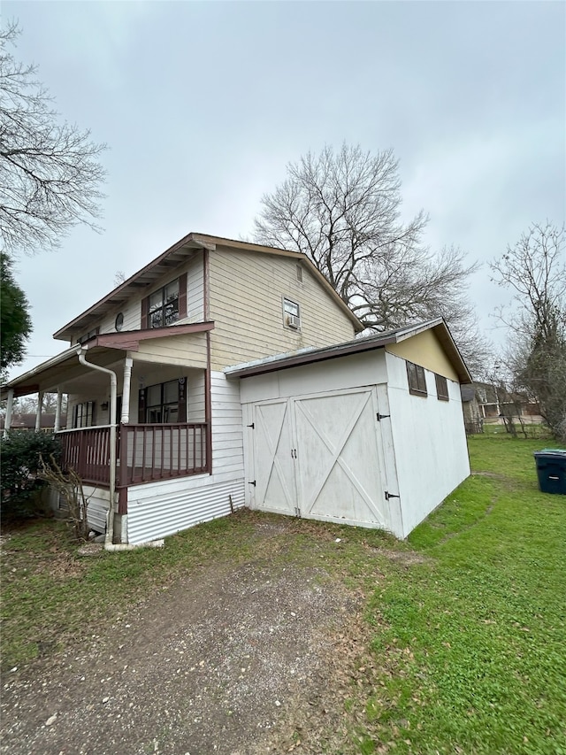 view of side of property with a yard and a porch