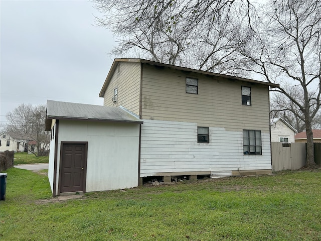 rear view of property with a lawn