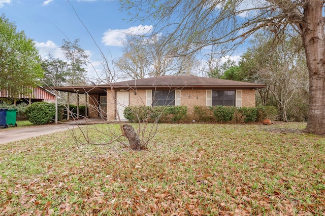 ranch-style house featuring a front yard and a carport